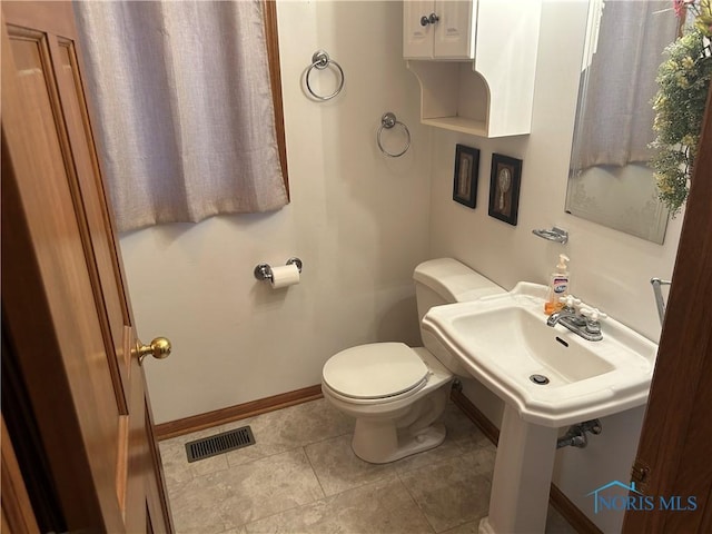 bathroom featuring tile patterned flooring and toilet