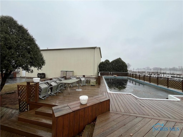 wooden terrace featuring a fenced in pool