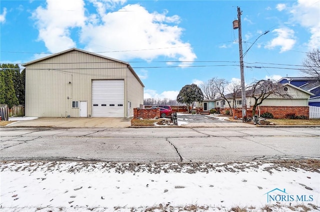 snow covered structure with a garage