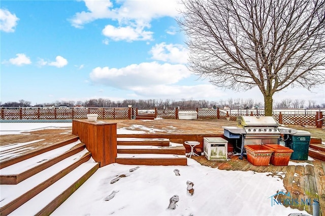 yard layered in snow featuring a deck