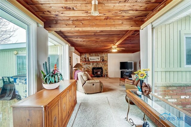 living room featuring light carpet and wood ceiling