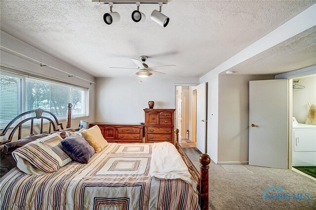 bedroom with ceiling fan, light colored carpet, rail lighting, and a textured ceiling