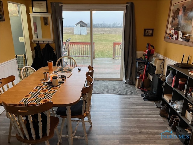 dining space with wood-type flooring