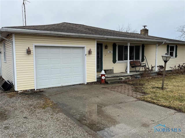 single story home with a garage, a front yard, and a porch