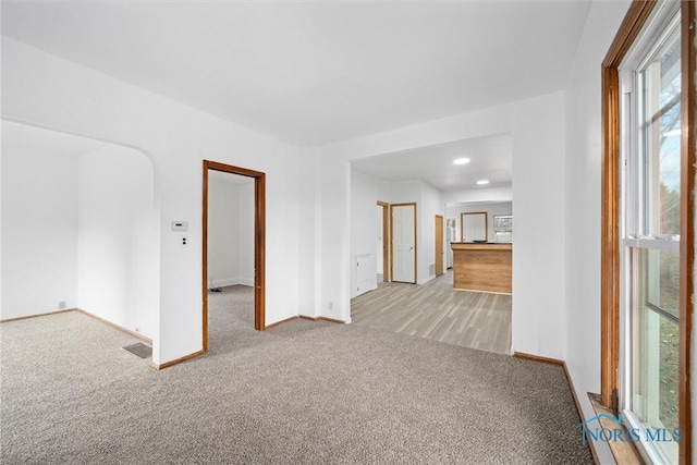 unfurnished room with light colored carpet