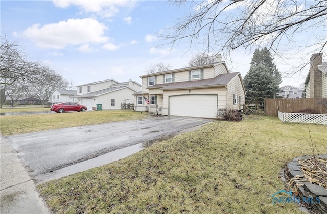 view of property with a garage and a front yard