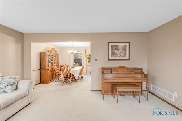 interior space with light colored carpet and a chandelier