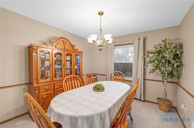 carpeted dining space with a chandelier