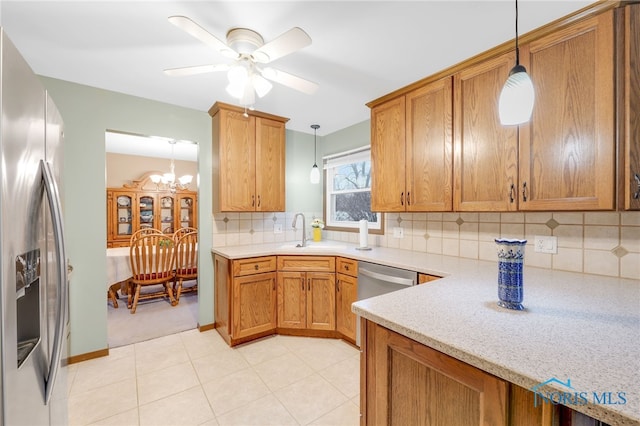 kitchen featuring pendant lighting, sink, tasteful backsplash, and appliances with stainless steel finishes