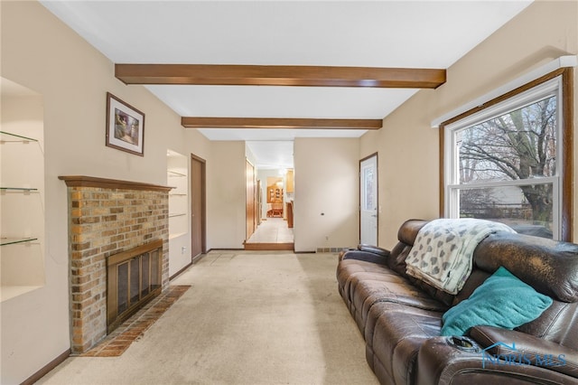 carpeted living room featuring beamed ceiling and a brick fireplace