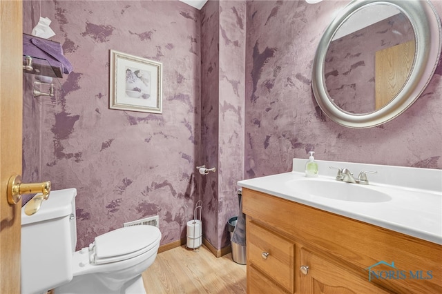 bathroom with vanity, hardwood / wood-style flooring, and toilet