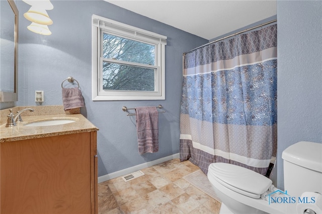 bathroom with vanity, toilet, and a shower with shower curtain