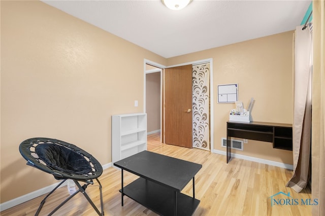 sitting room with hardwood / wood-style flooring