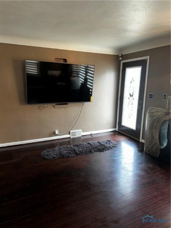 entrance foyer with dark hardwood / wood-style floors