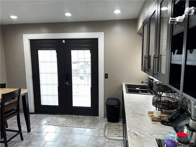 interior space featuring sink, light tile patterned floors, and french doors