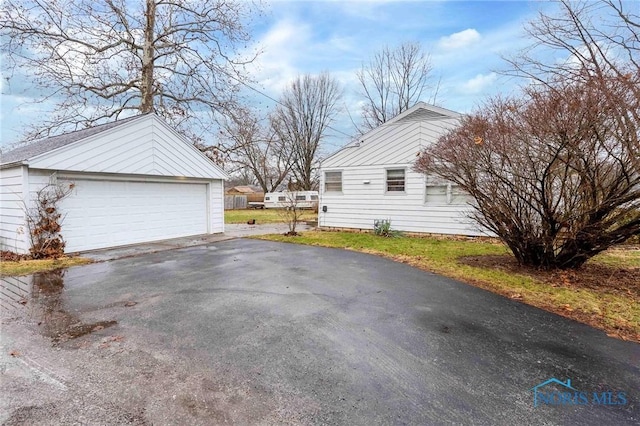 view of side of property with a garage and an outdoor structure