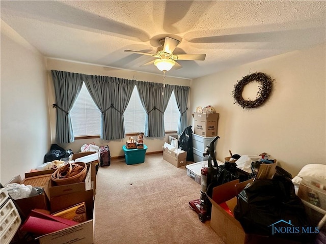 interior space with ceiling fan, carpet floors, and a textured ceiling