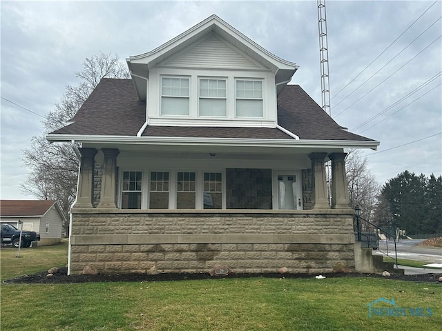 view of front of home with a porch and a front lawn