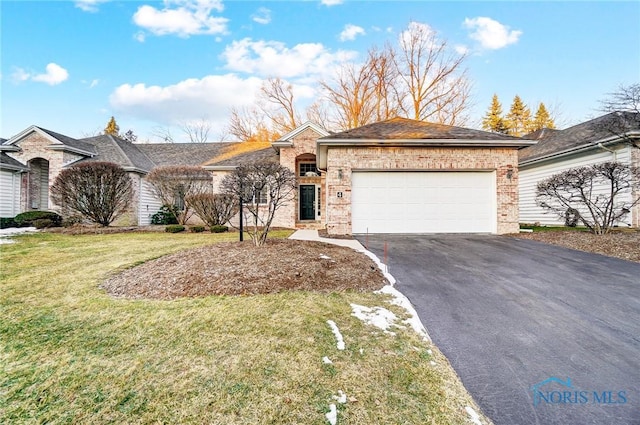 single story home with a garage and a front lawn