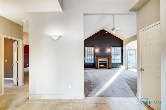 interior space featuring high vaulted ceiling and light carpet