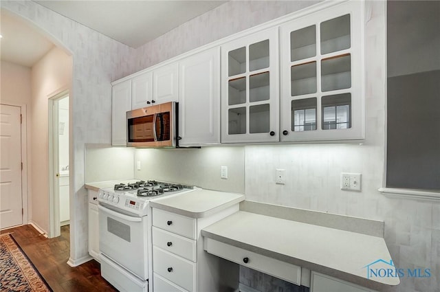 kitchen featuring white cabinetry, white range with gas cooktop, and dark wood-type flooring