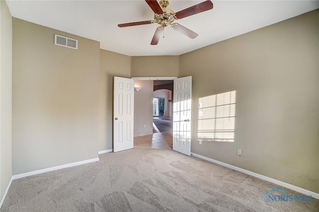 unfurnished bedroom with light colored carpet and ceiling fan