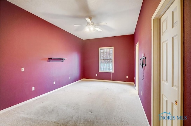 unfurnished room with light colored carpet and ceiling fan