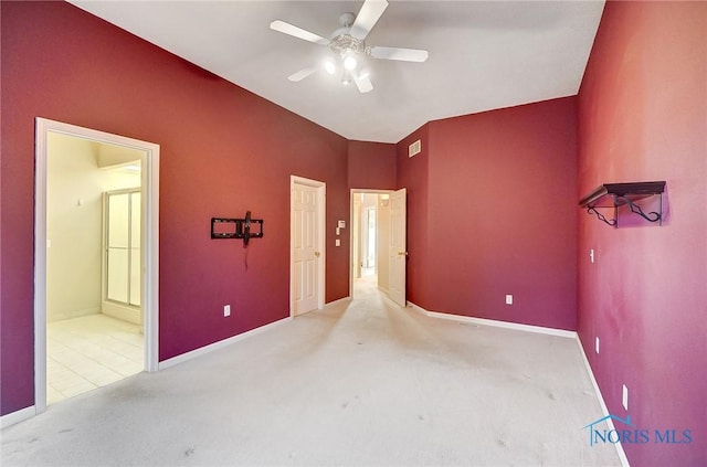 unfurnished bedroom featuring ceiling fan, ensuite bathroom, and light carpet