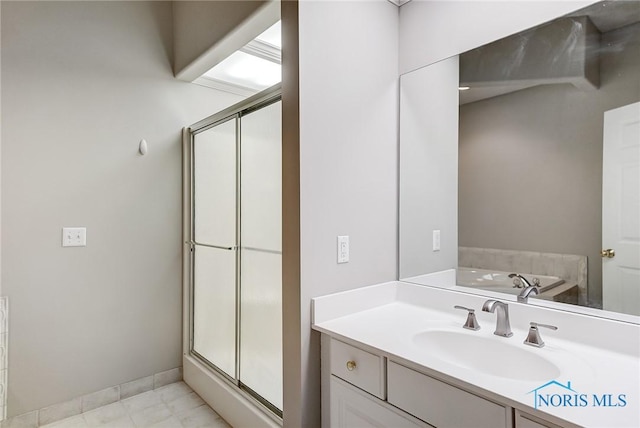 bathroom with vanity and independent shower and bath