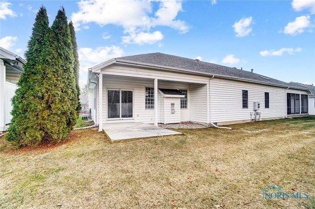 back of property featuring a patio and a lawn