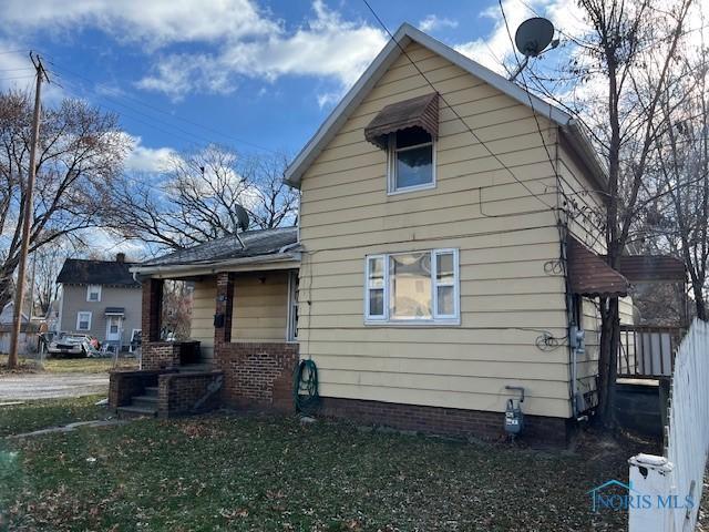 rear view of house with a yard