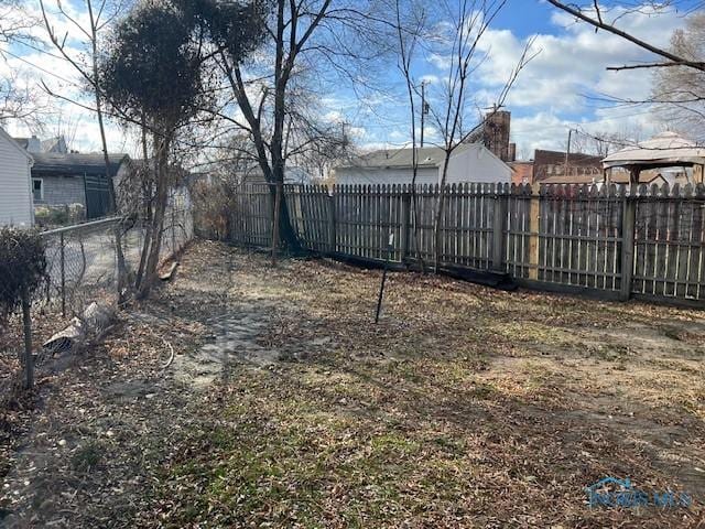 view of yard with a fenced backyard and a gazebo