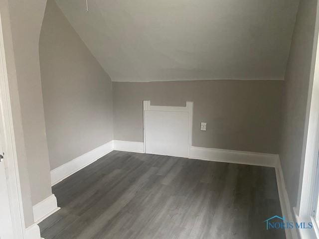 bonus room featuring lofted ceiling, wood finished floors, and baseboards