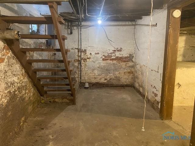 unfinished basement featuring stairs