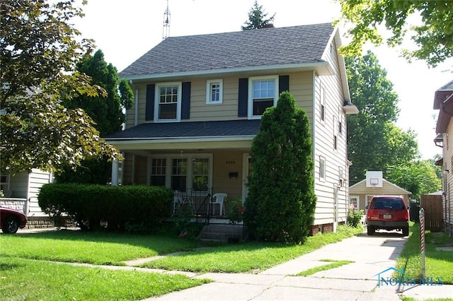 view of front facade with a front yard and covered porch