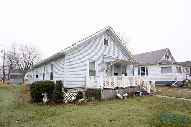 back of house featuring a wooden deck and a lawn