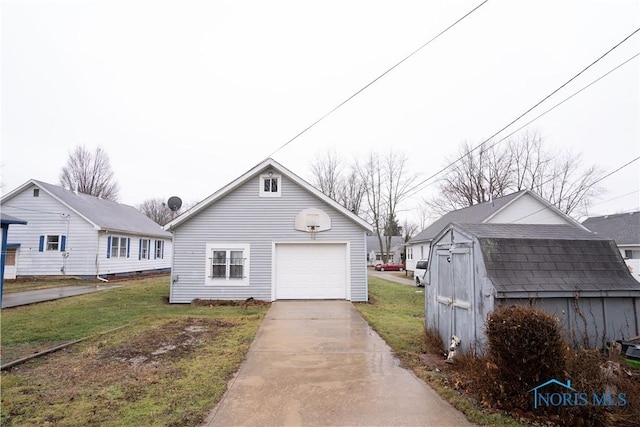 view of front facade with a garage, an outdoor structure, and a front lawn