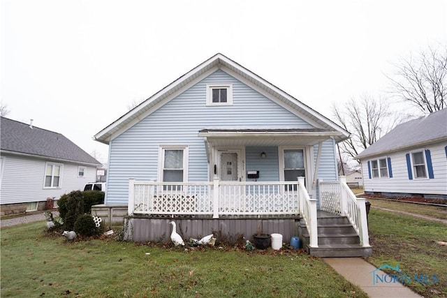 bungalow-style home featuring a porch and a front lawn