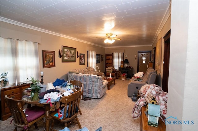 dining area with carpet floors, ornamental molding, and ceiling fan