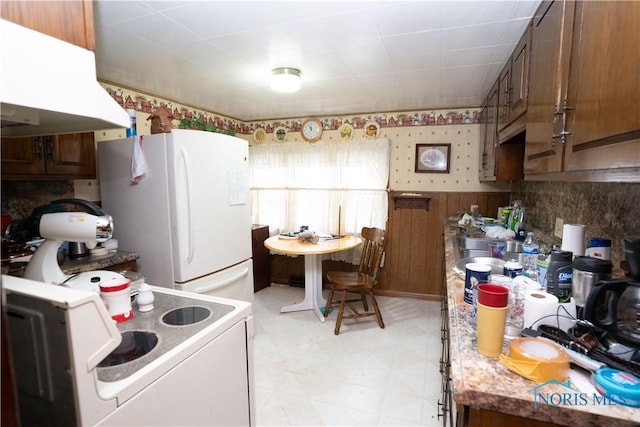 kitchen featuring white appliances and exhaust hood