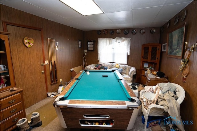 game room with pool table, wooden walls, and light colored carpet