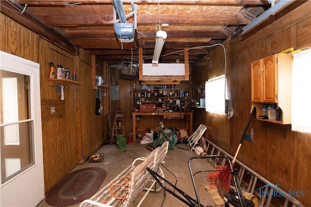 miscellaneous room featuring wooden walls and a workshop area