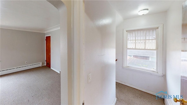 hall featuring light colored carpet and a baseboard heating unit