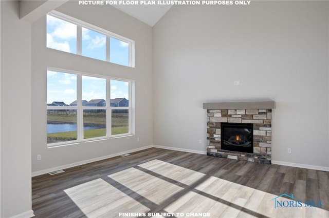 unfurnished living room featuring a fireplace, dark wood-type flooring, a high ceiling, and a water view