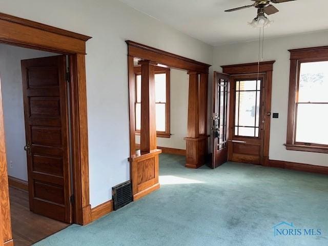 interior space with dark colored carpet and ceiling fan