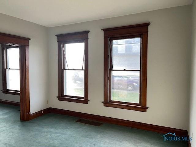 carpeted spare room with plenty of natural light