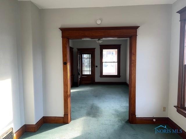 hallway featuring dark carpet