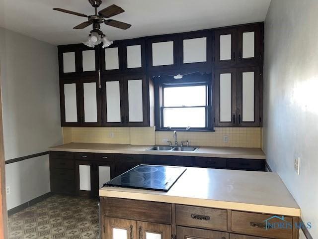 kitchen with sink, black electric stovetop, ceiling fan, and decorative backsplash