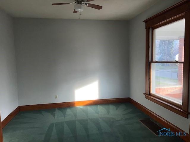 carpeted empty room with ceiling fan