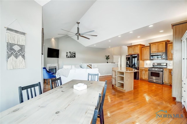 dining area featuring lofted ceiling, light hardwood / wood-style flooring, and ceiling fan